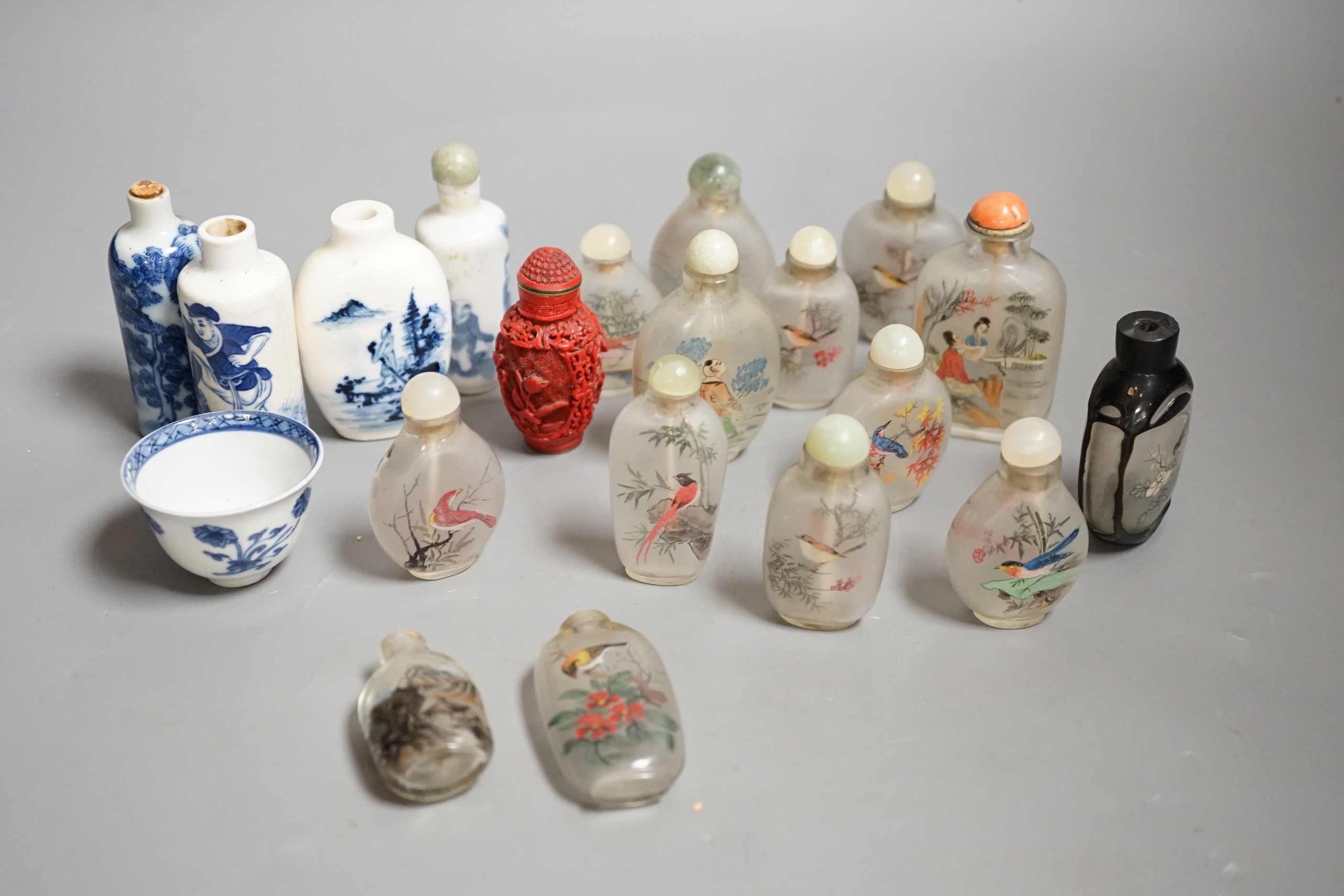 A collection of 20th century Chinese export reverse painted snuff bottles with associated blue and white porcelain examples, some 19th century